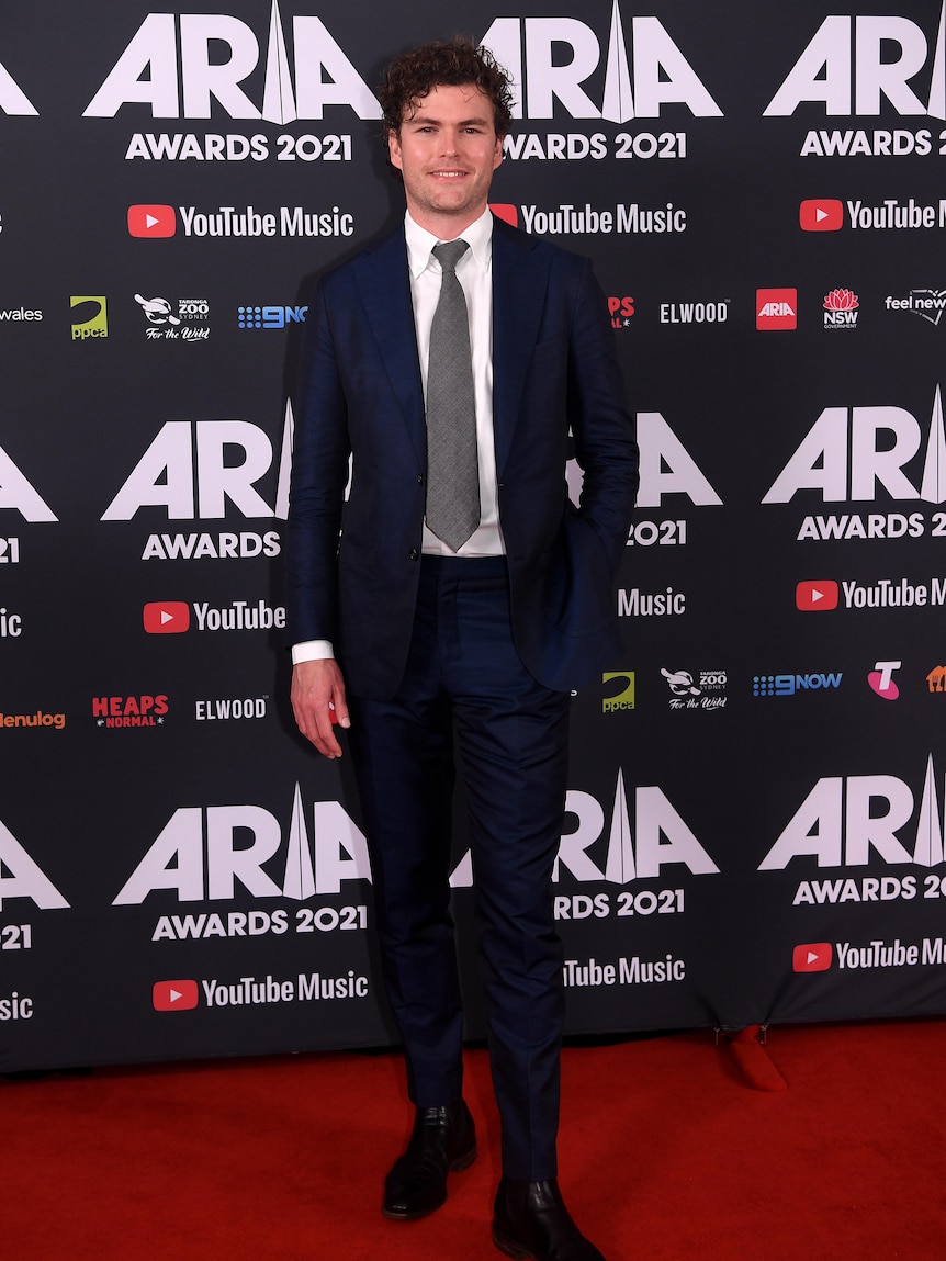 A man in a suit on the red carpet.