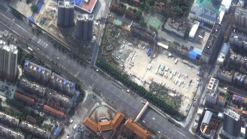 Satellite imagery shows a wide avenue in Wuhan, China, that's largely deserted, with only a handful of cars.
