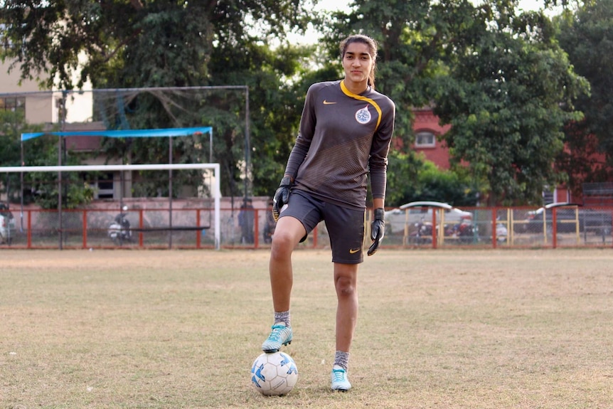 Afshan Ashiq stands on the ball