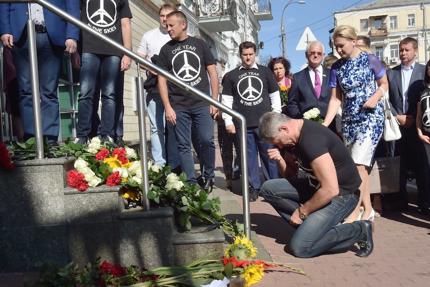 People mark one year since MH17 disaster by leaving flowers at Dutch embassy in Kiev