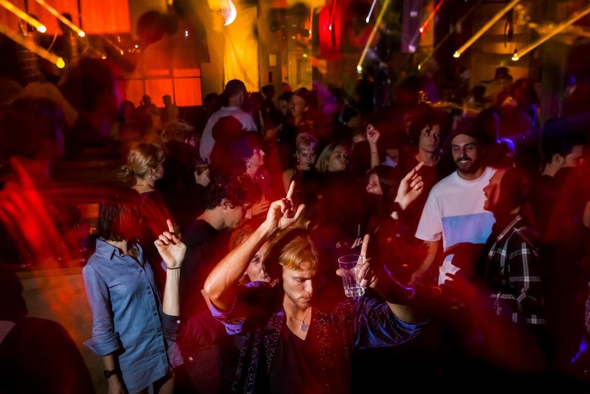 People dance at a nightclub.