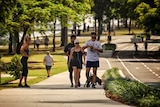People walking and jogging along a path in a park