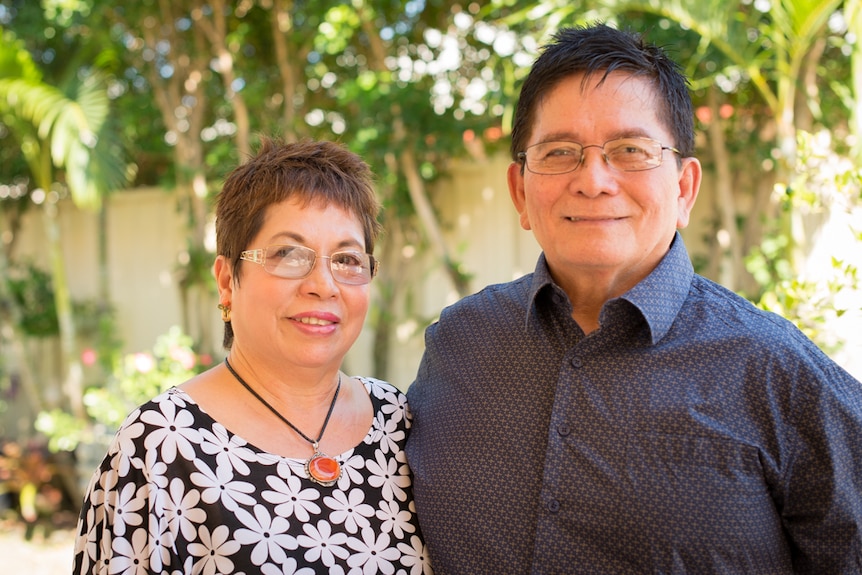Filipino immigrants Edna and John Rivas smile for a portrait style photograph in the back garden of their Darwin home.