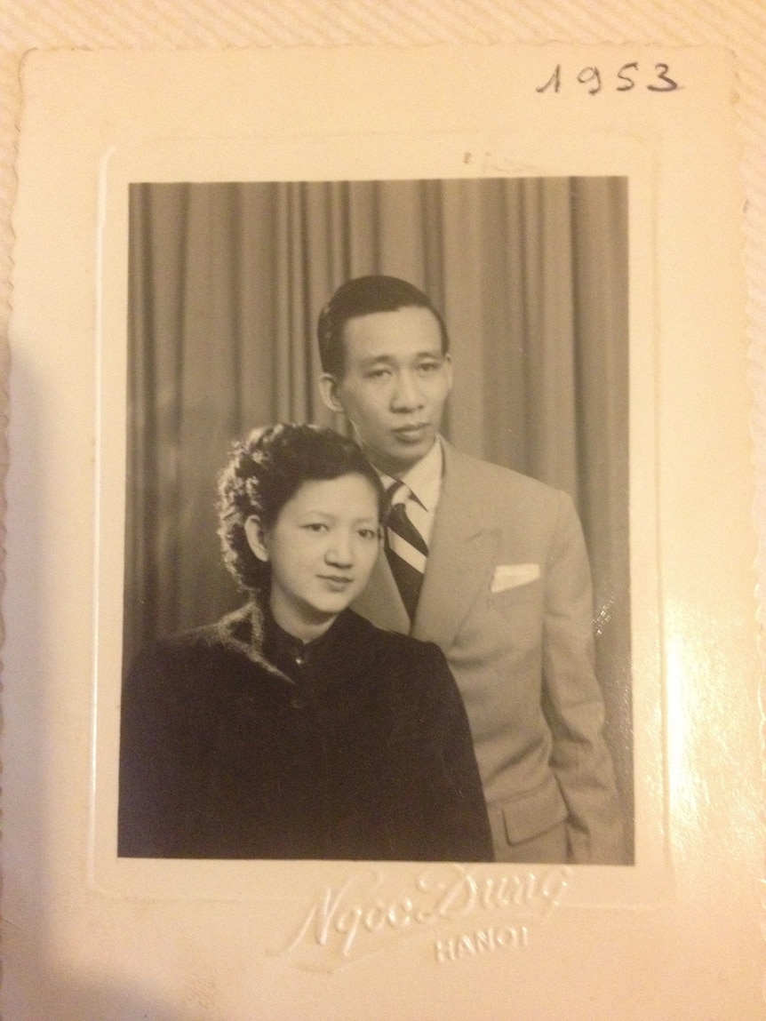 A photo of a black and white studio portrait of a young Vietnamese couple taken in the 50s