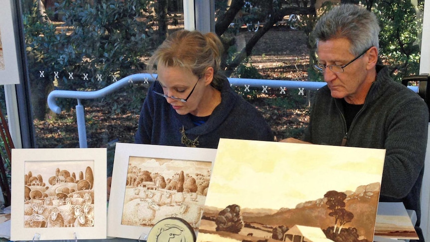 Beverley McNamara and Alex Nicholas use melted chocolate to create paintings in Tasmania.