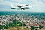 Discovery, mounted atop a Boeing 747, flies over Washington DC