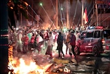 Fire crackers explode near protesters during clashes with police in Jakarta.