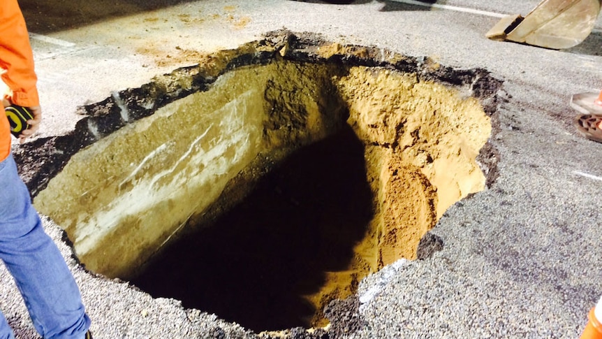 A pothole closes the Bruce Highway in north Queensland, south of Bowen.