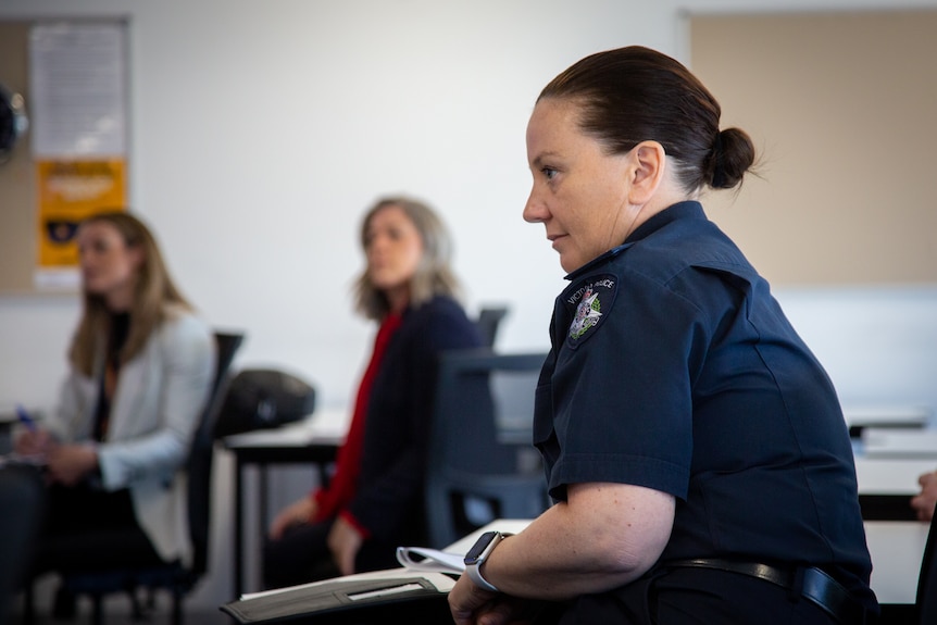 A younger woman in police uniform pictured in profile.