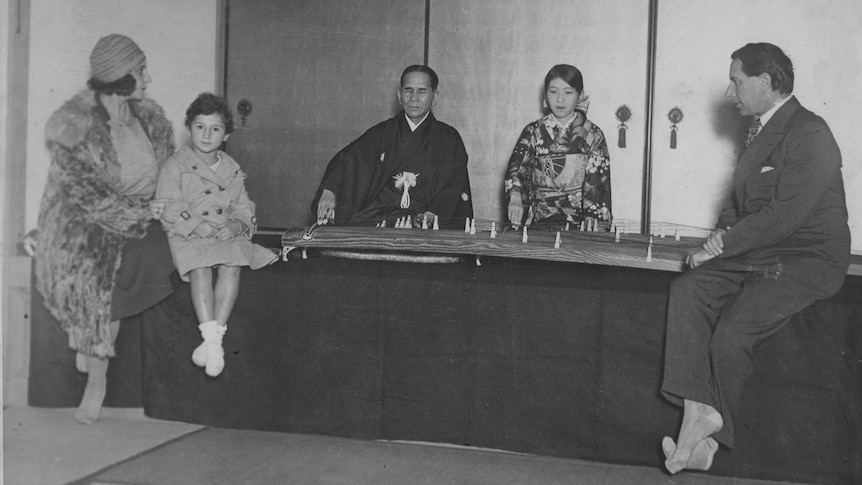 A young Beate Sirota, with her mother and father, listening to a performance of the koto.