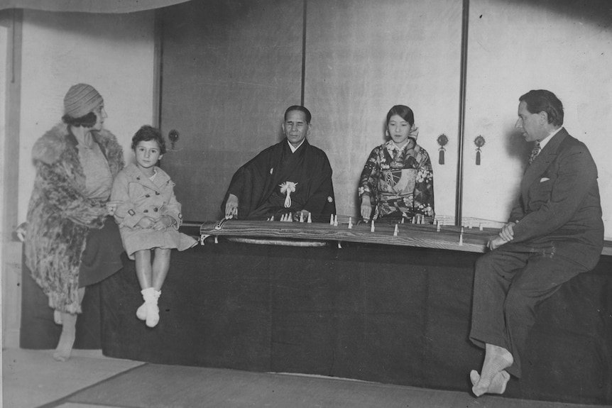 A young Beate Sirota, with her mother and father, listening to a performance of the koto.