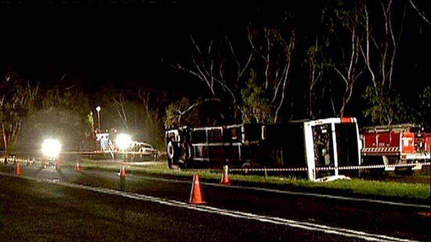 A VLine bus lies on its side after overturning on the Princes Highway at Heathmere