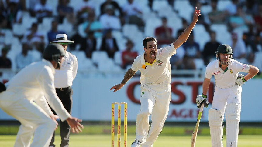 Australia bowler Mitchell Johnson puts a finger up and shouts for a wicket. South Africa batter AB de Villiers is behind him.