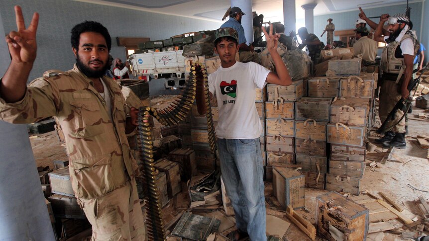 Libyan fighters after finding a weapon's depot in the village of Qasr Abu Hadi, the birthplace of Moamer Gaddafi.