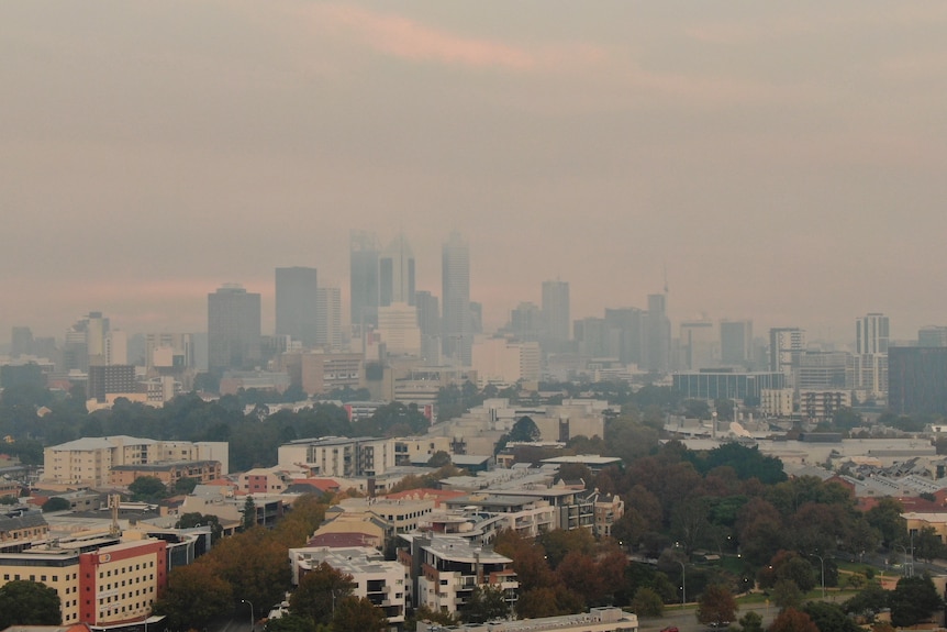 A city skyline engulfed by smoke haze