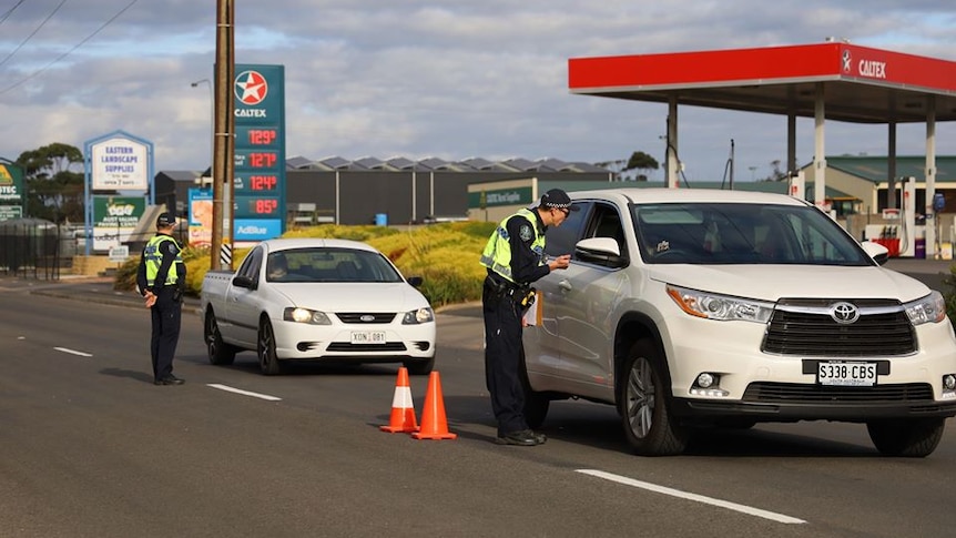 A police officer talks to a driver through the window of a car travelling into Mount Gambier from Victoria.