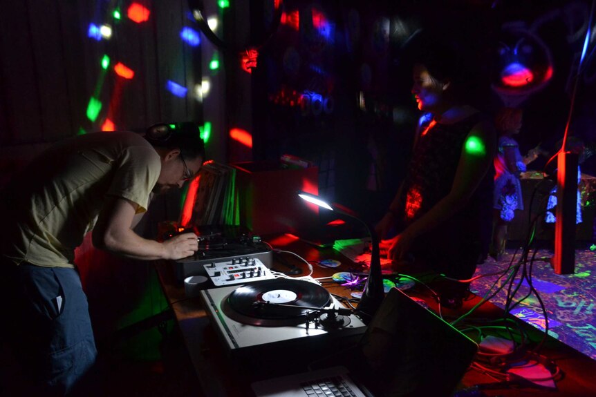 Julian Scharf DJs under lights.