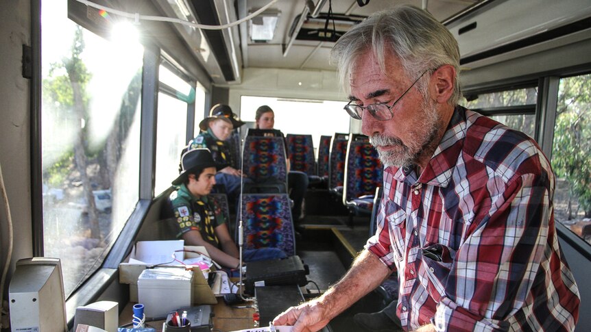 Tony Falla inside the bus with his radio equipment.