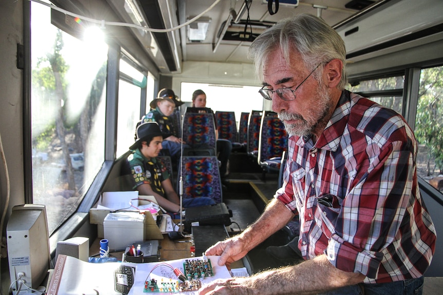 Tony Falla inside the bus with his radio equipment.