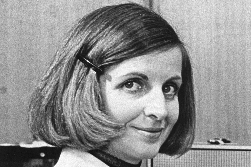 Black and white headshot woman with bob hair clipped back