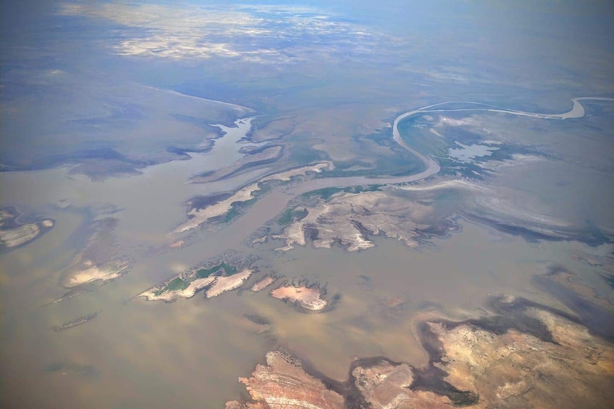 An aerial photo of rivers filling up a lake.
