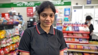 A woman standing in a convenience store.