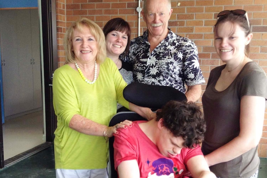 Rory O'Connor, who is severely disabled in a wheelchair, surrounded by family members.