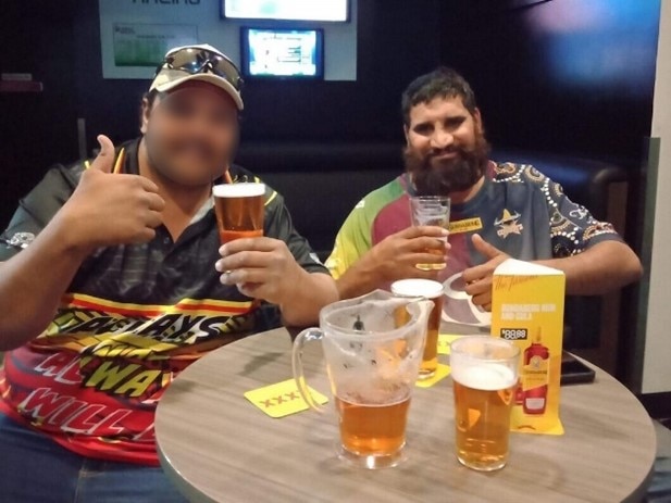 Two men drinking beers