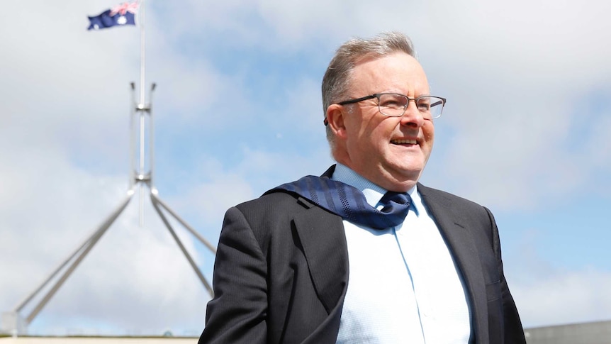 Anthony Albanese outside Parliament House in the wind.