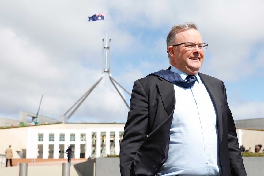 Anthony Albanese outside Parliament House in the wind.
