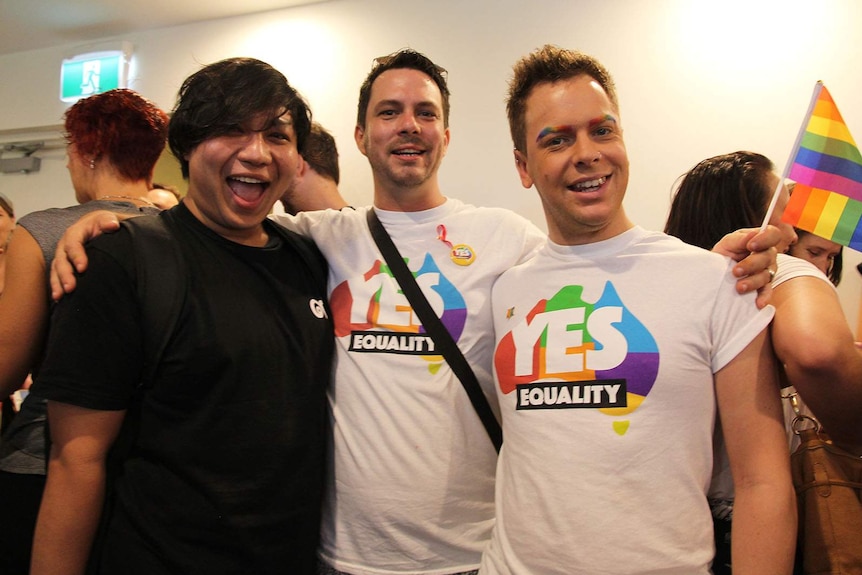 Teddy Suphannabutt, James Emery, and Phillip Coffey with rainbow flags and eyebrows.