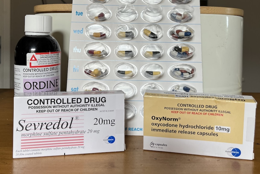 Packets of the opioid medicines Ordine, Sevredol and OxyNorm arranged on a table.