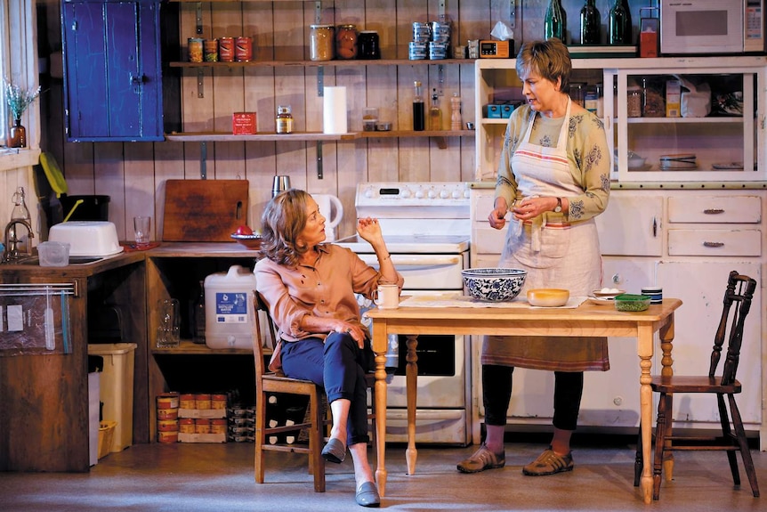 Actors Sarah Peirse and Pamela Rabe at the kitchen table, in a scene from the play.
