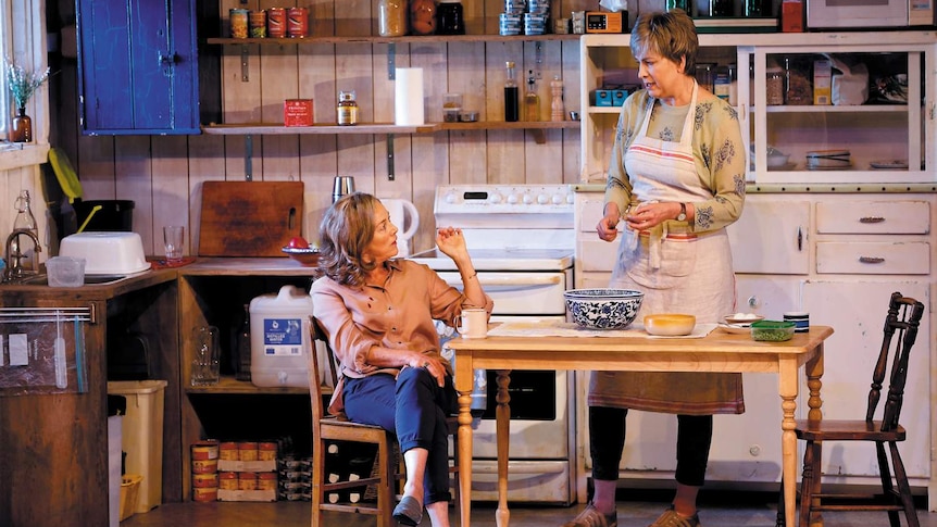 Actors Sarah Peirse and Pamela Rabe at the kitchen table, in a scene from the play.