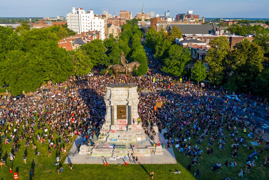 A large group of protesters gather around the statue of Confederate General Robert E Lee in Richmond, Virginia