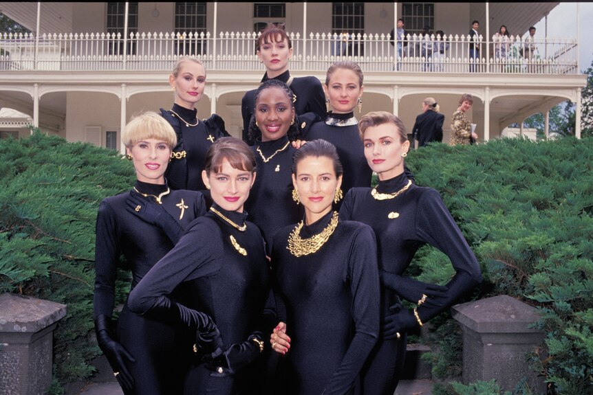 A group of women wearing black model jewellery.