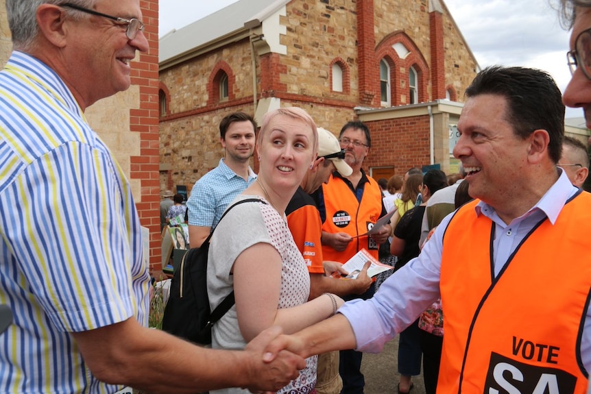 Nick Xenophon shakes hands with a voter.