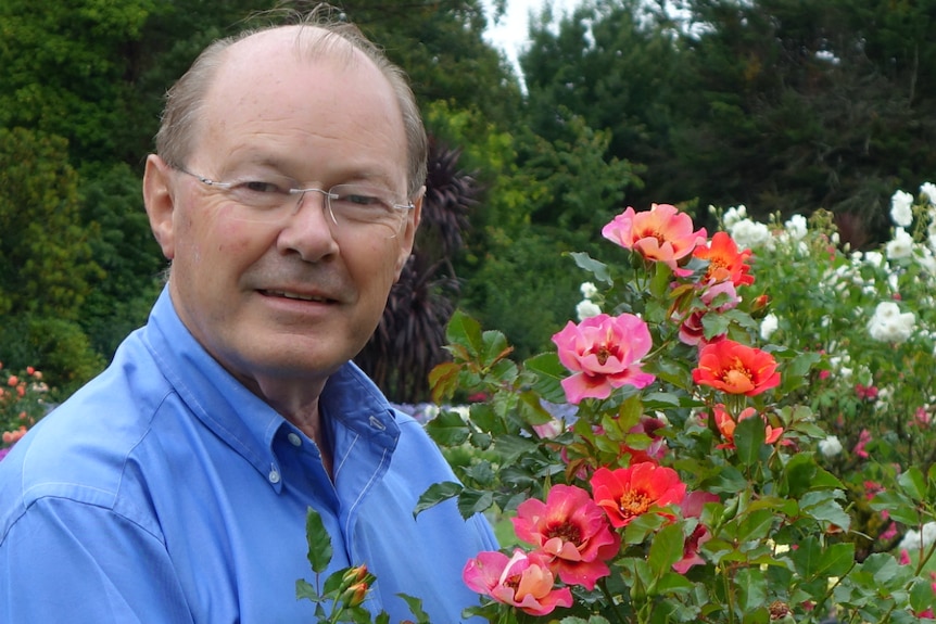 Anthony Tesselaar posing with flowers.