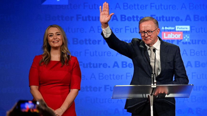 Anthony Albanese, leader of Australia's Labor Party stands next to his partner Jodie Haydon, while he addresses his supporters