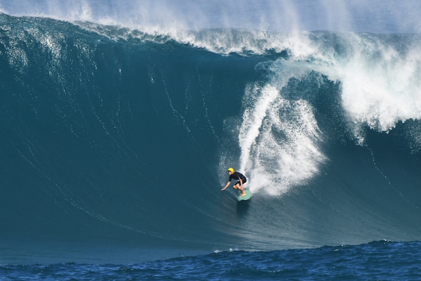 A man riding a large wave