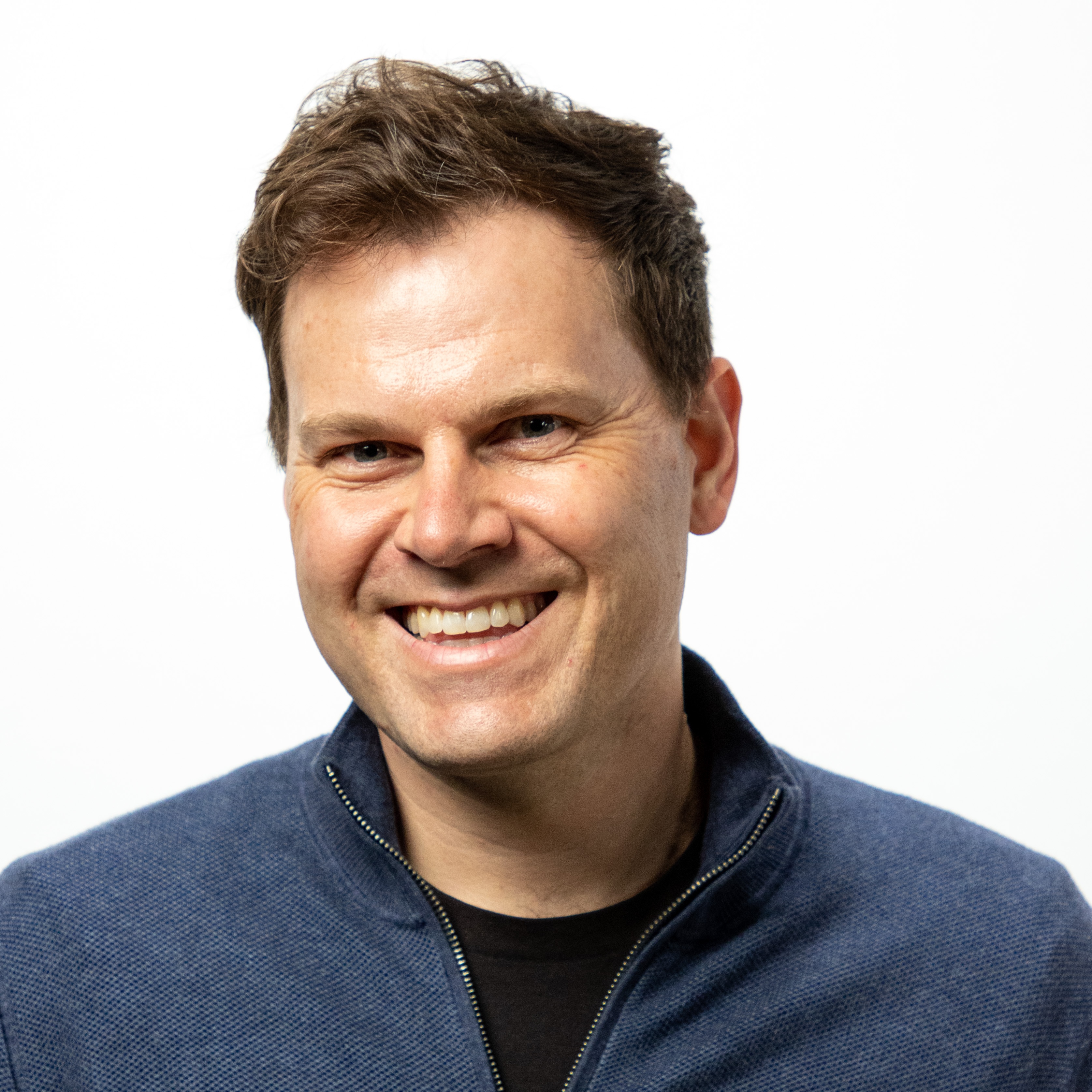 A portrait of a man, smiling.