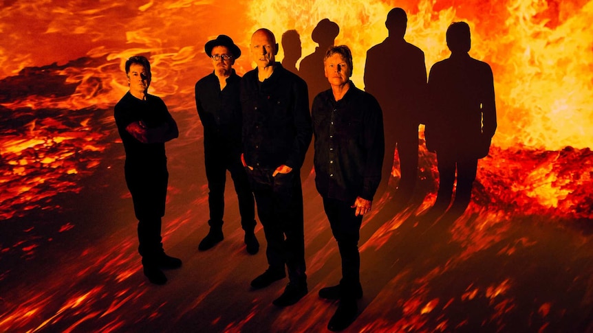Australian band Midnight Oil with a burning background