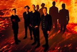 Australian band Midnight Oil with a burning background