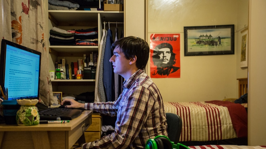 Jack Surplice studies on a computer in his room.