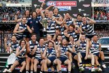 Geelong celebrates with the AFL trophy after winning the 2022 grand final.