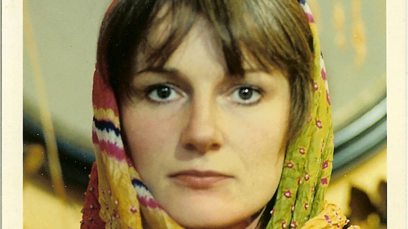 A portrait of Amanda Feilding wearing a headscarf.