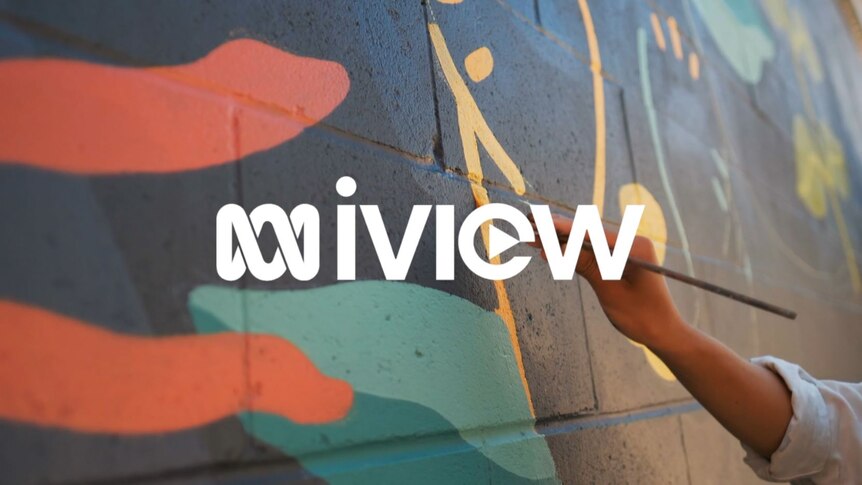 A hand paints a mural on a wall, text overlay reads 'iview'