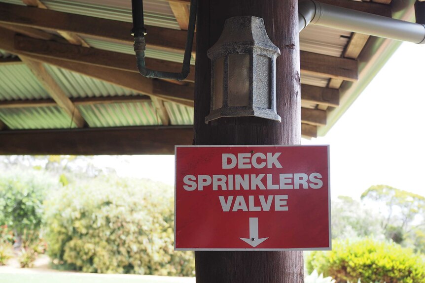 A sign alerting visitors to a deck sprinklers valve on Mr Mitchell's property.