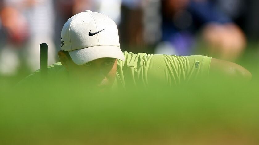 Closing in: Tiger Woods lines up a putt