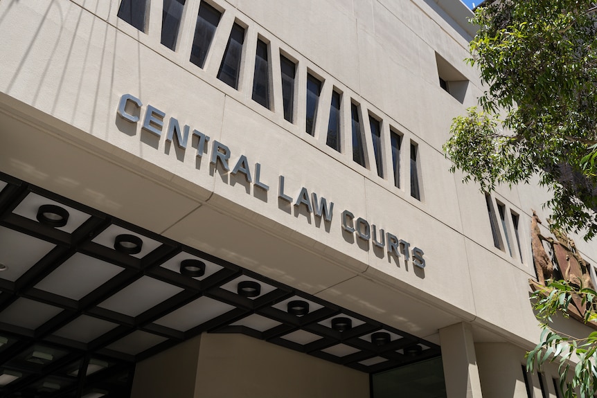 A shot of a grey building with the words 'central law courts' written on the side. 